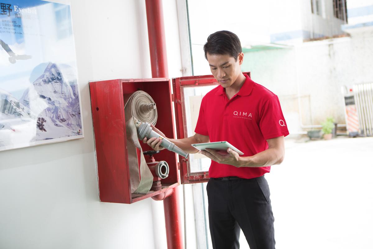 inspector inspecting fire extinguisher